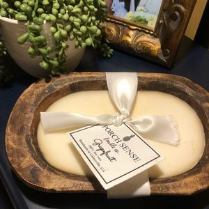 Grapefruit scent soy candle in wooden dough bowl